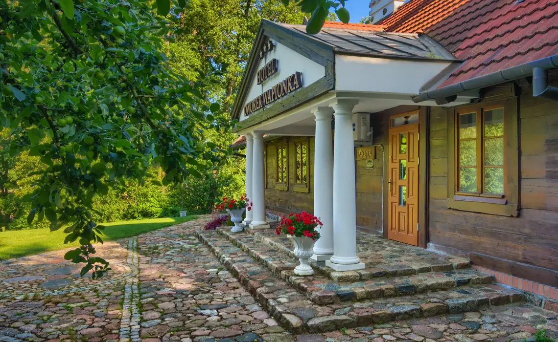 Historyczny budynek Hotelu Dworek Wapionka wśród zieleni